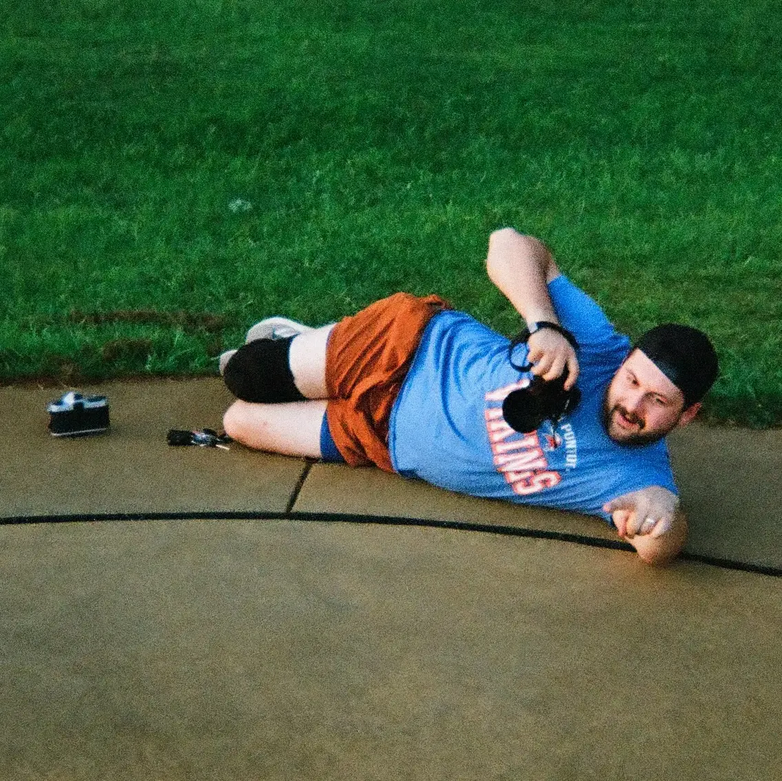 Caleb Mooneyham, photographer, lying on the ground taking a photo